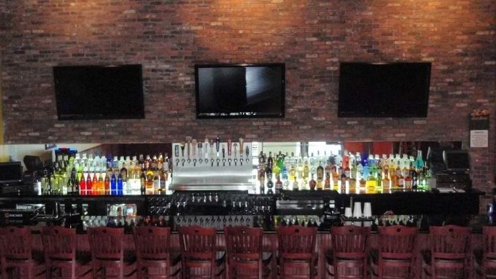 Casual bar tables with warm indoor lighting.